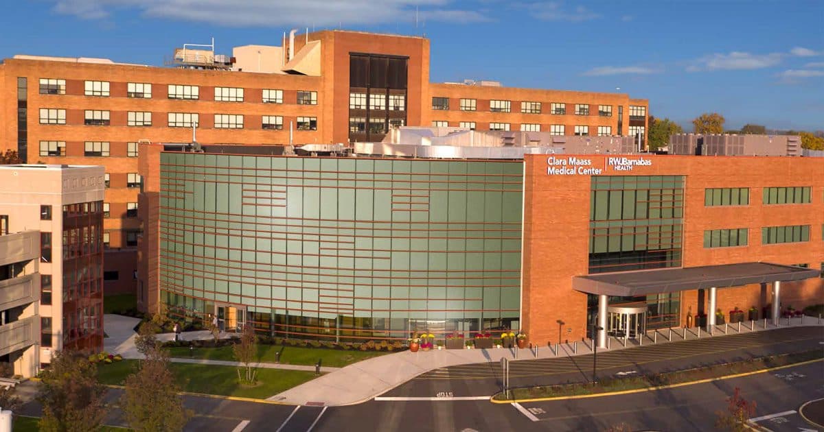 Clara Maass Medical Center, a brick hospital with a glass entrance, seen from above