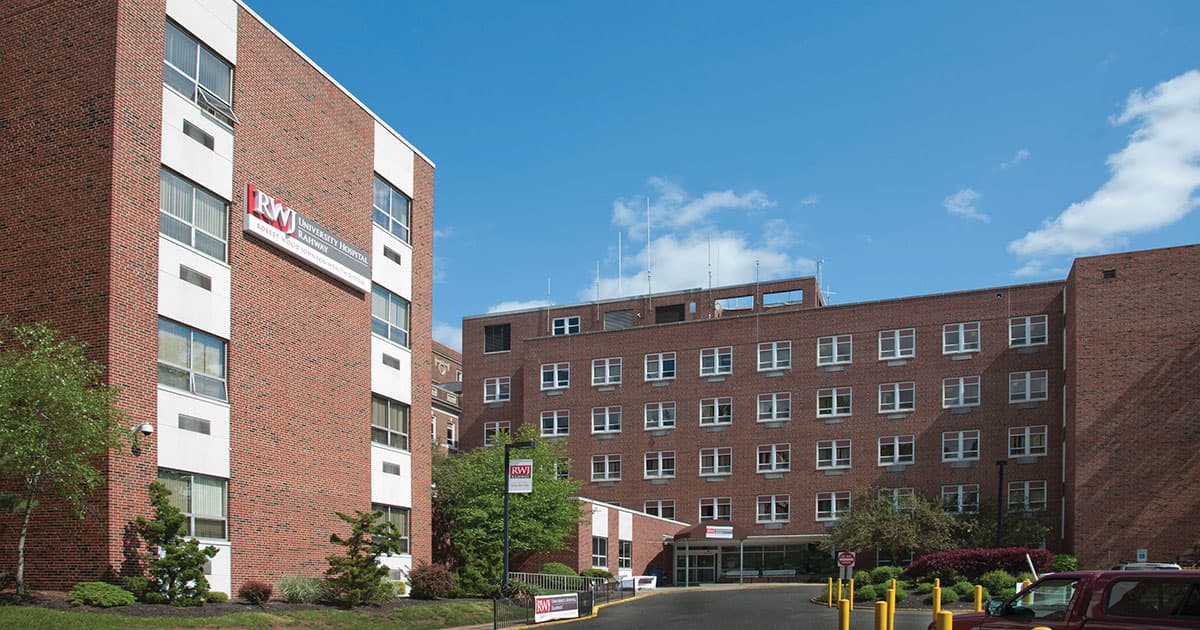 The red-brick towers of RWJ University Hospital Rahway under a blue sky